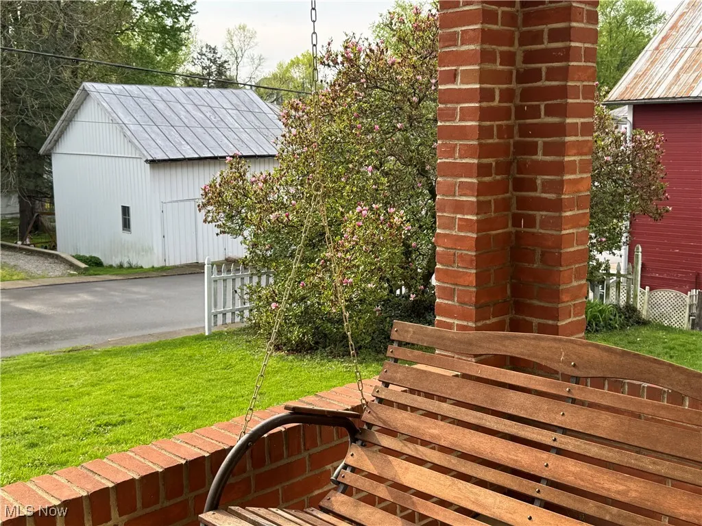 View of yard featuring fence and an outdoor structure
