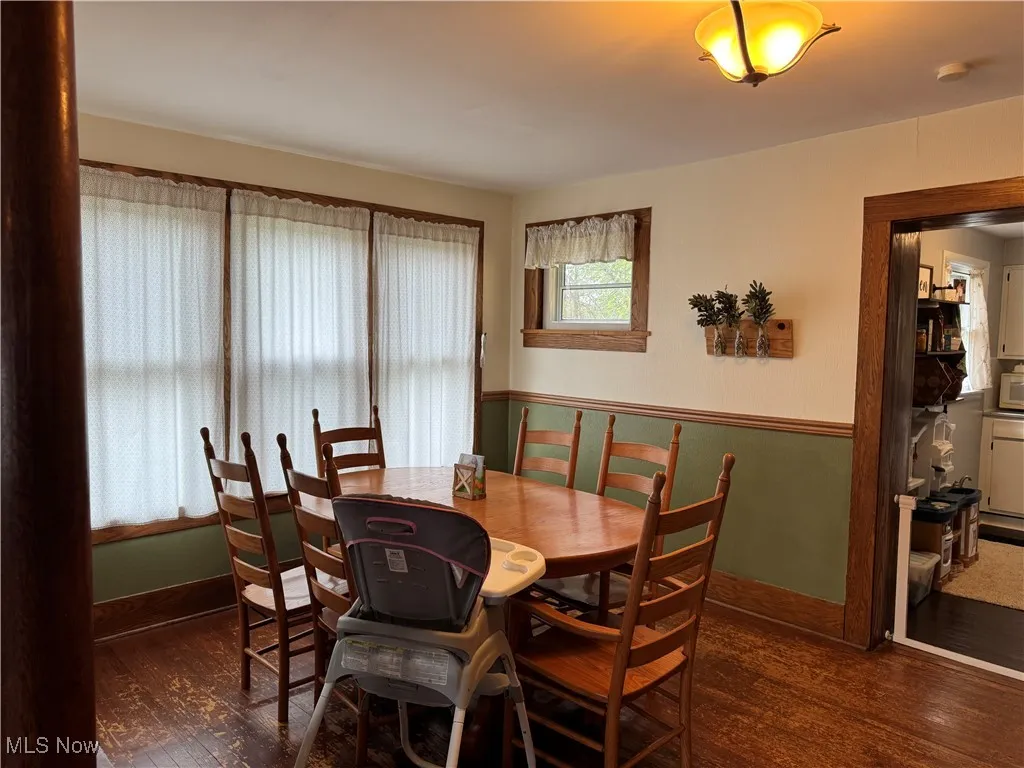 Dining area with baseboards and wood finished floors