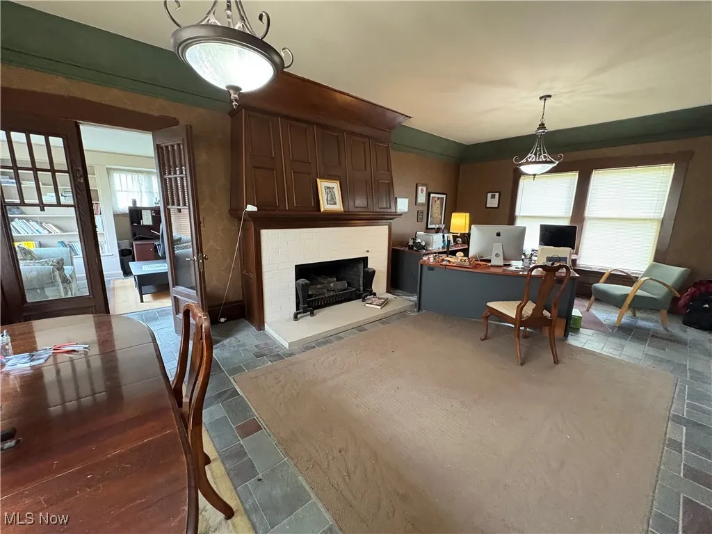 Living area featuring a fireplace and stone tile floors