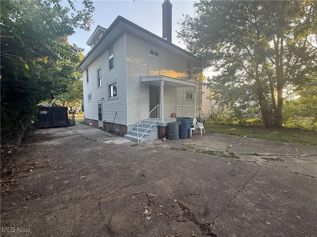 View of front of home featuring a chimney and driveway