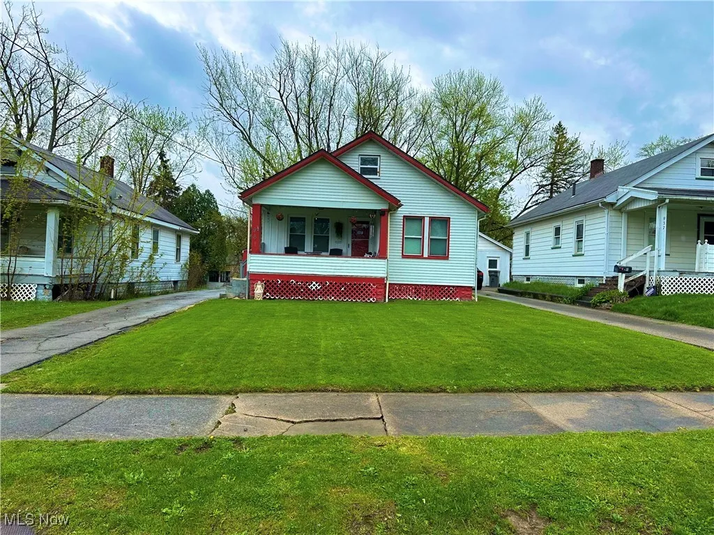 Bungalow-style home with covered porch and a front lawn