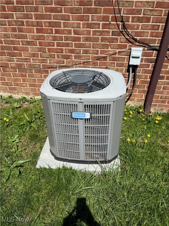 Details featuring brick siding and central AC unit