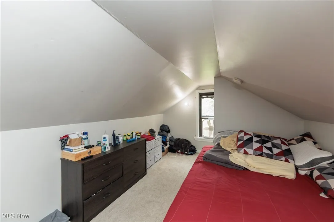 Carpeted bedroom with vaulted ceiling