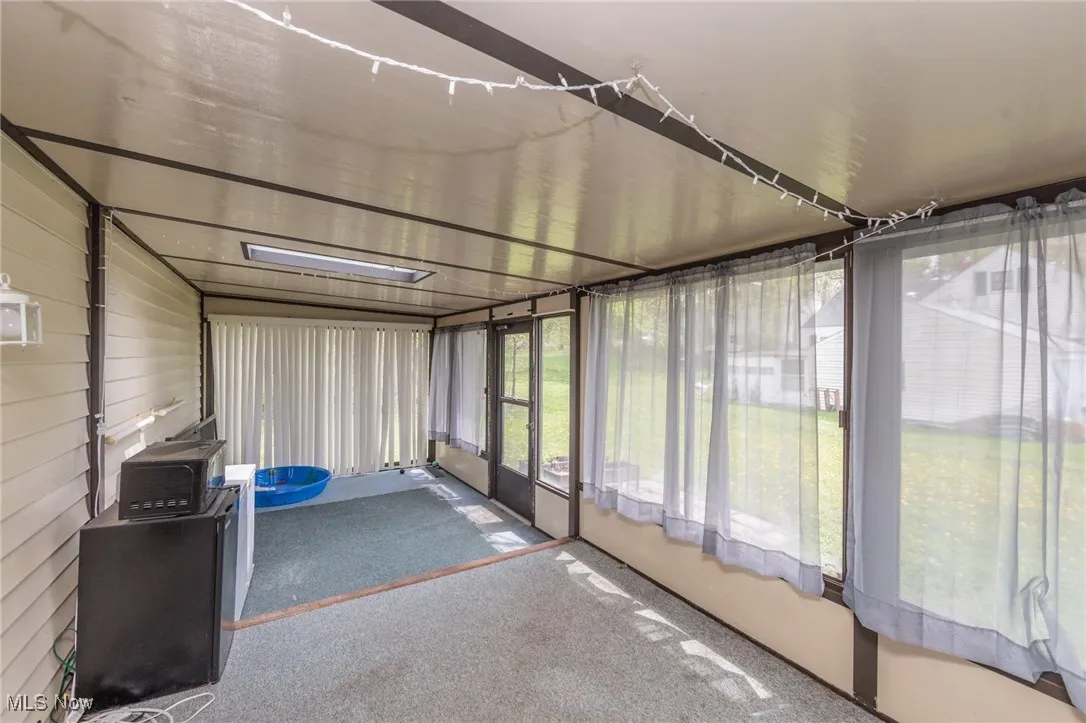 Unfurnished sunroom featuring carpet floors
