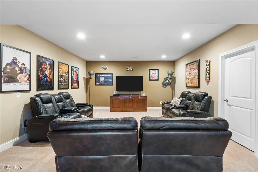 Living area with baseboards, recessed lighting, and light colored carpet