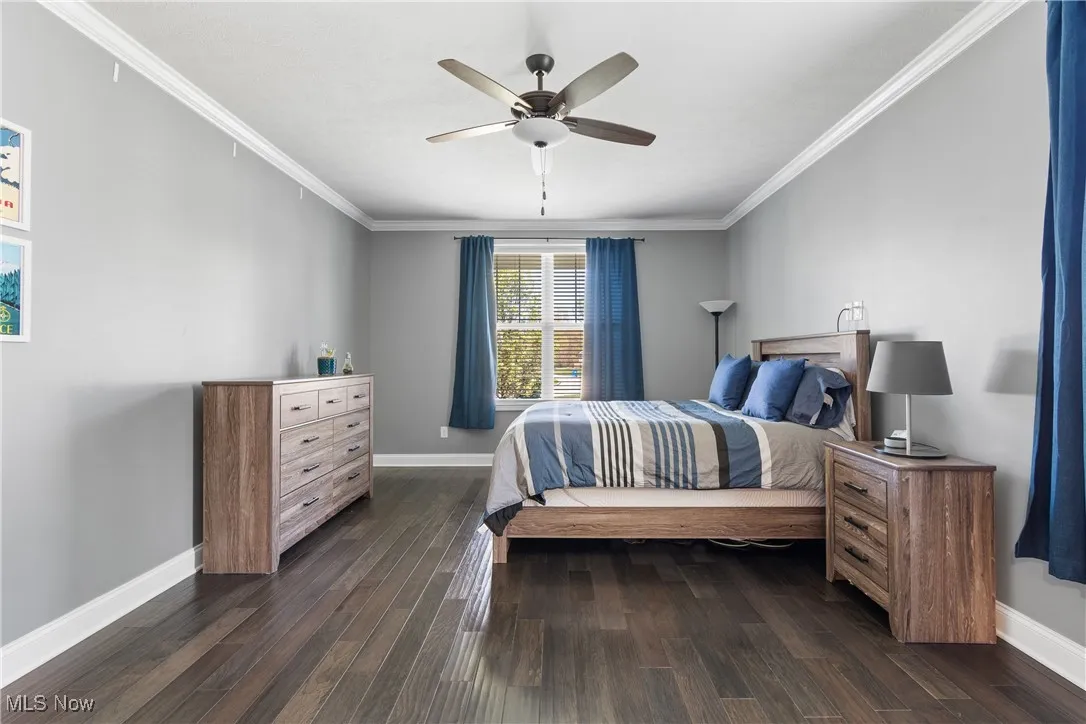 1st floor Bedroom featuring crown molding, baseboards, and dark wood-type flooring