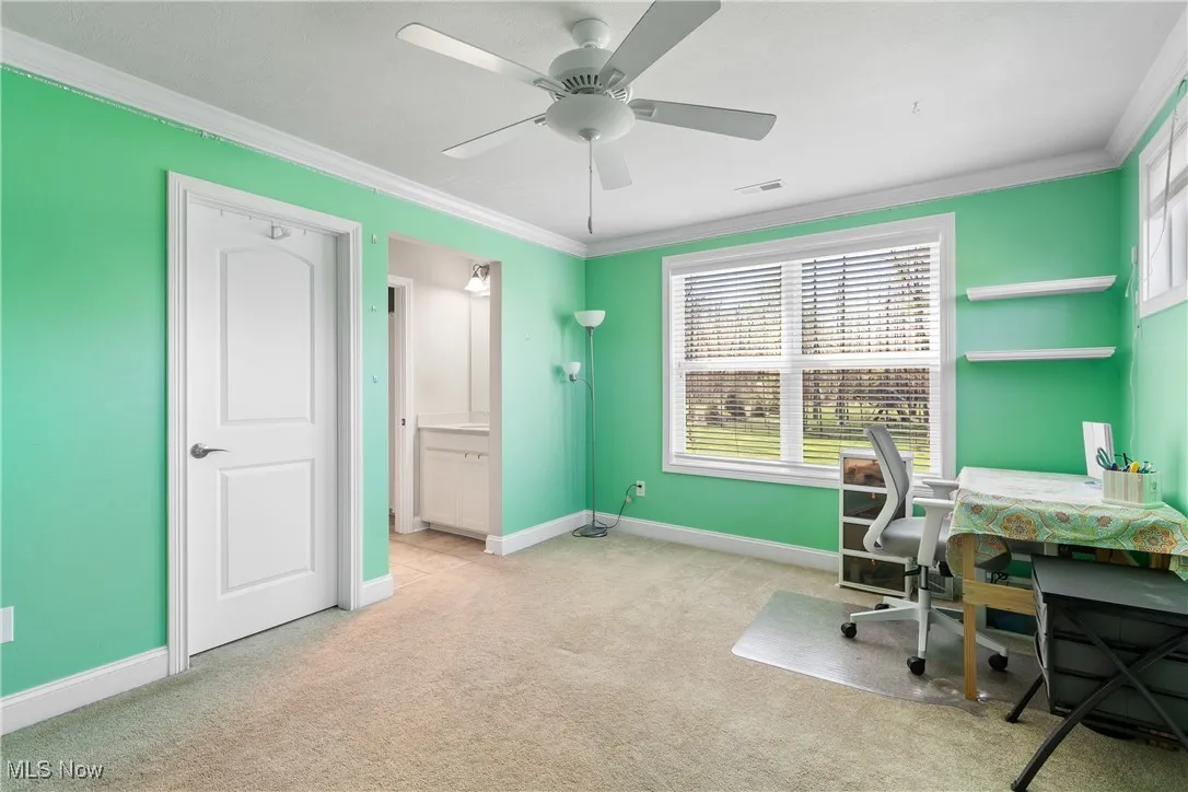 Office area featuring crown molding, baseboards, and light colored carpet