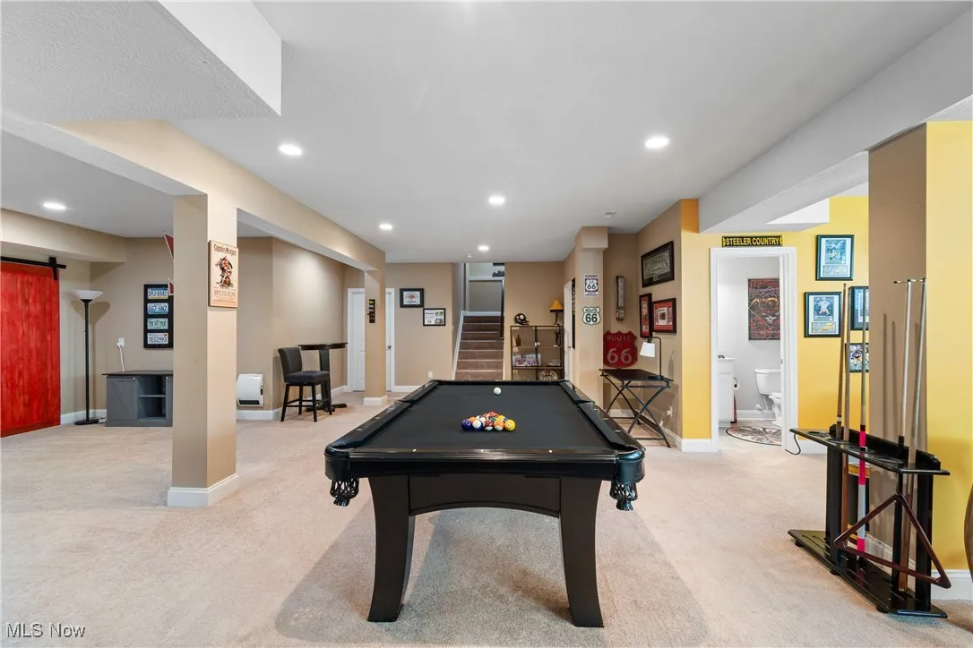 Game room with recessed lighting, pool table, light carpet, and a barn door