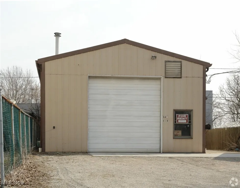 Detached garage featuring fence
