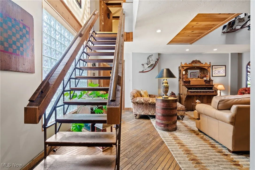 Stairway with hardwood / wood-style flooring, baseboards, and recessed lighting