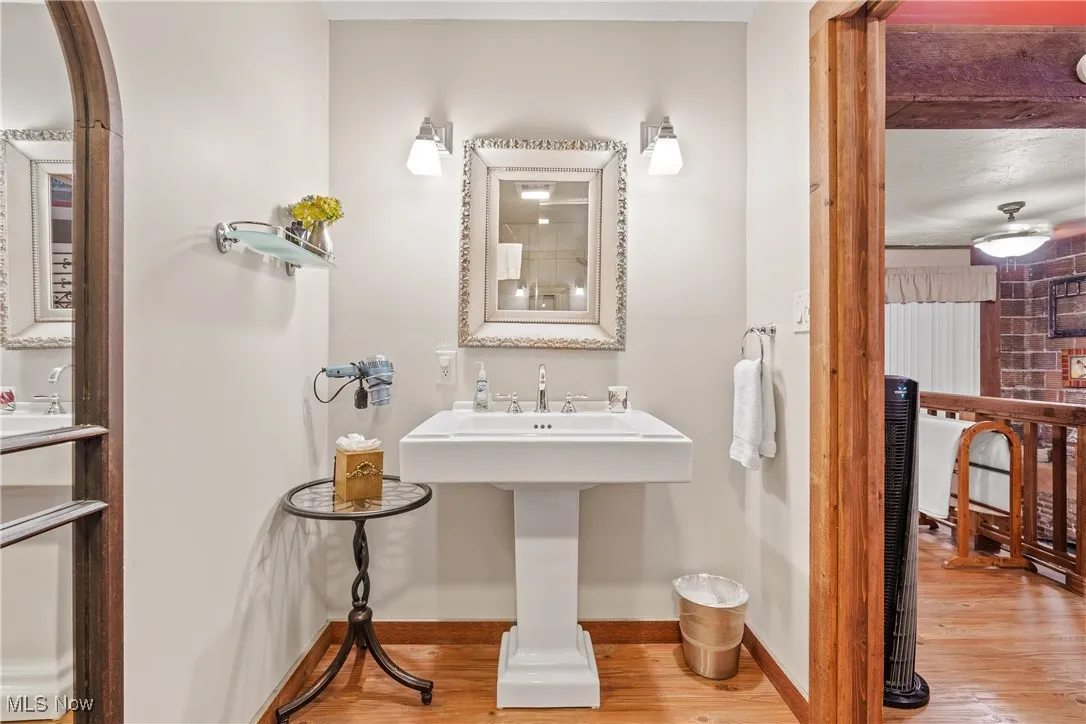 Another view of the Updated Ensuite Bath for rear unit with pocket door and pedestal sink