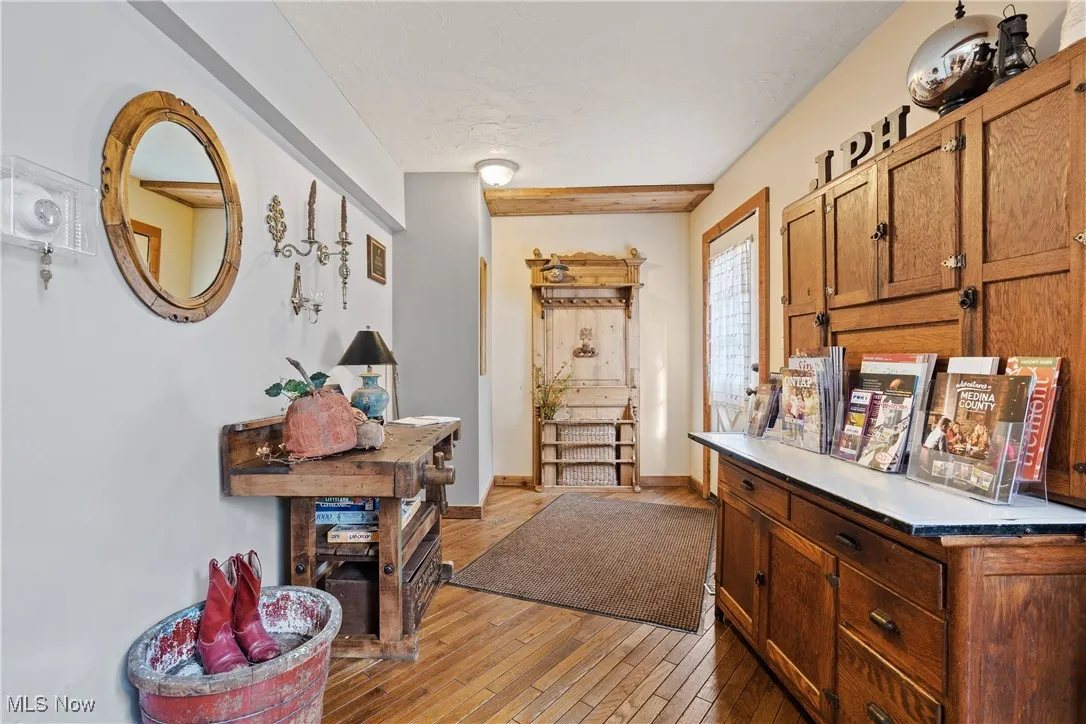 Corridor with baseboards and light wood finished floors