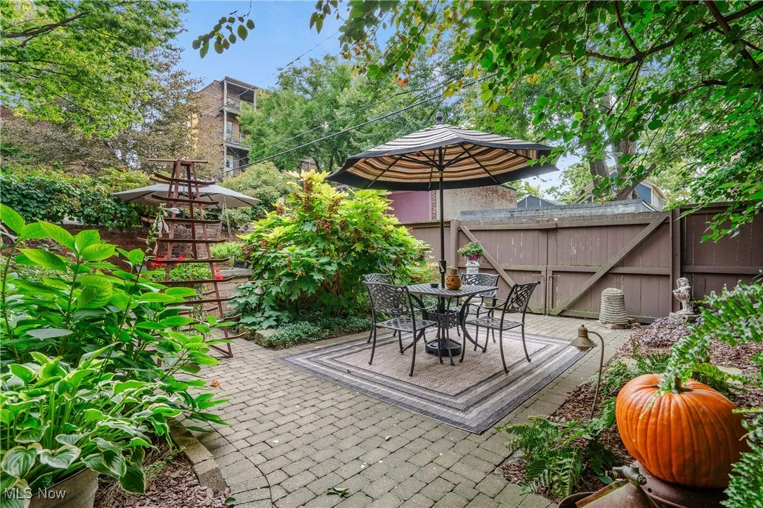 View of courtyard patio. It is fully fenced in. The wood gate has access to the back alley. You can use this side of the patio to park a car