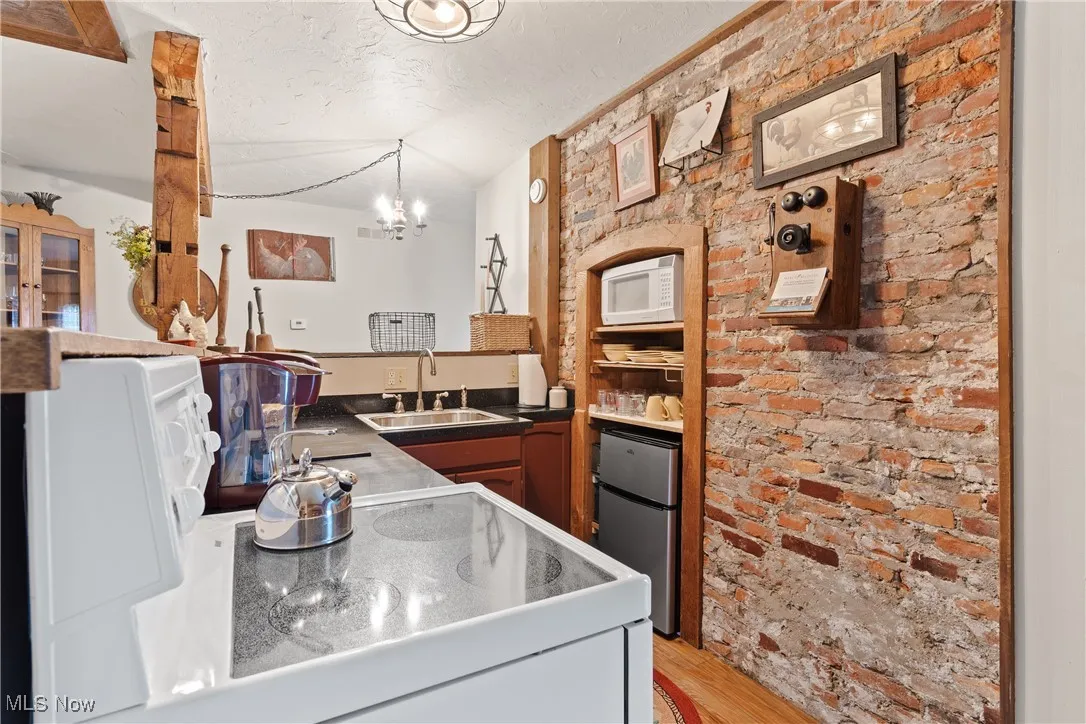 Rear unit Kitchen with original exposed brick wall with insert which can accommodate a larger retro style refrigerator
