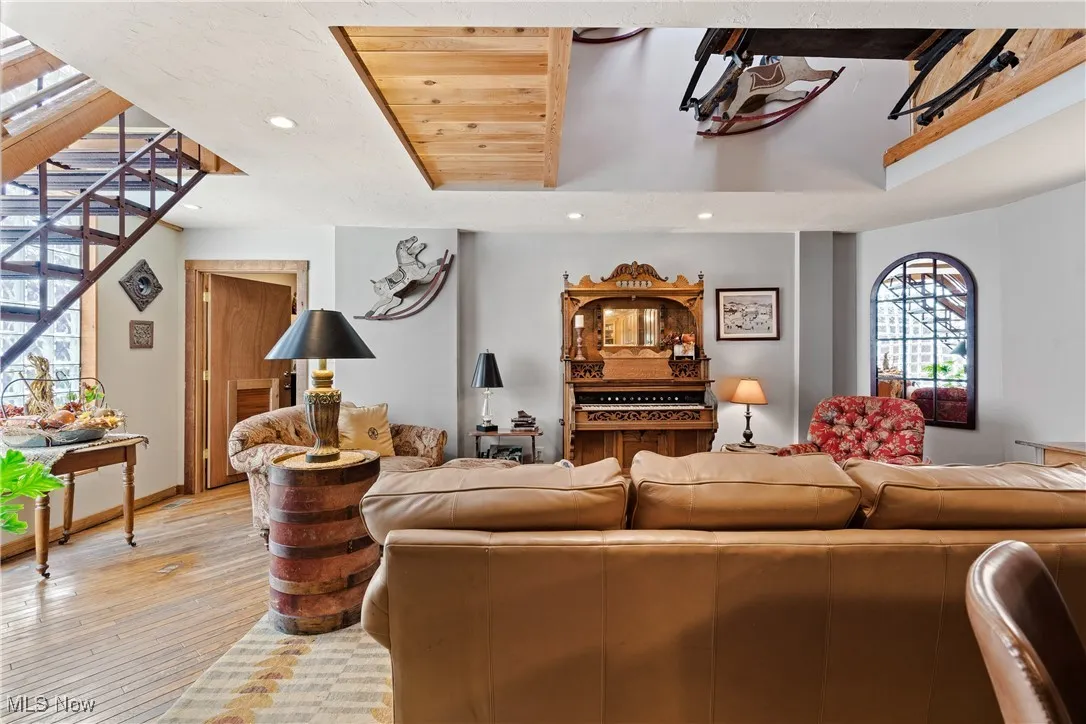 Living room with recessed lighting, light wood finished floors, and baseboards