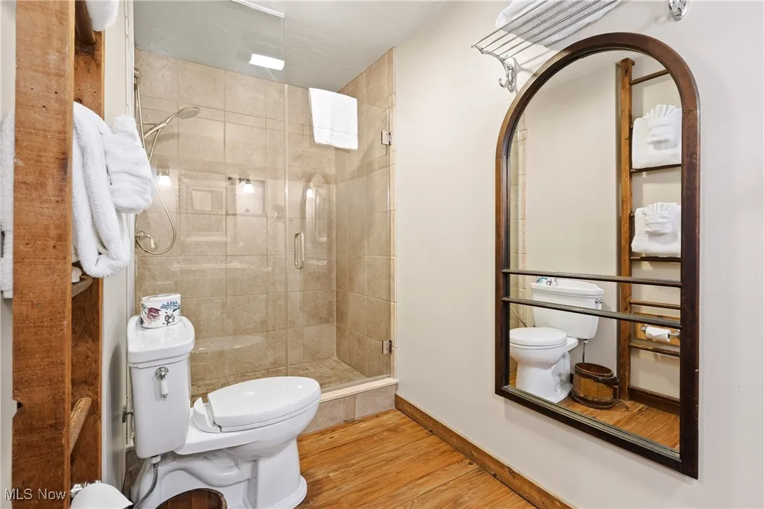 Updated Ensuite Bath for the rear unit has tiled shower with seamless glass doors