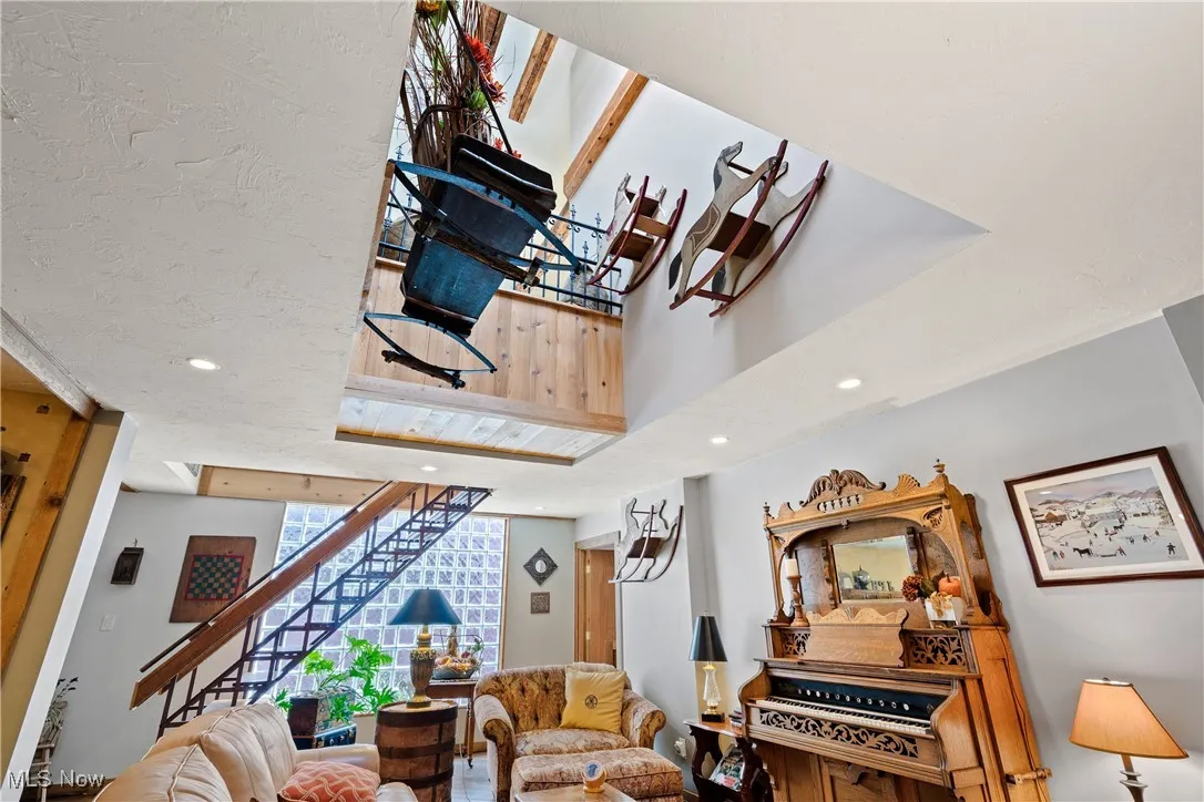 Living room featuring stairs and recessed lighting