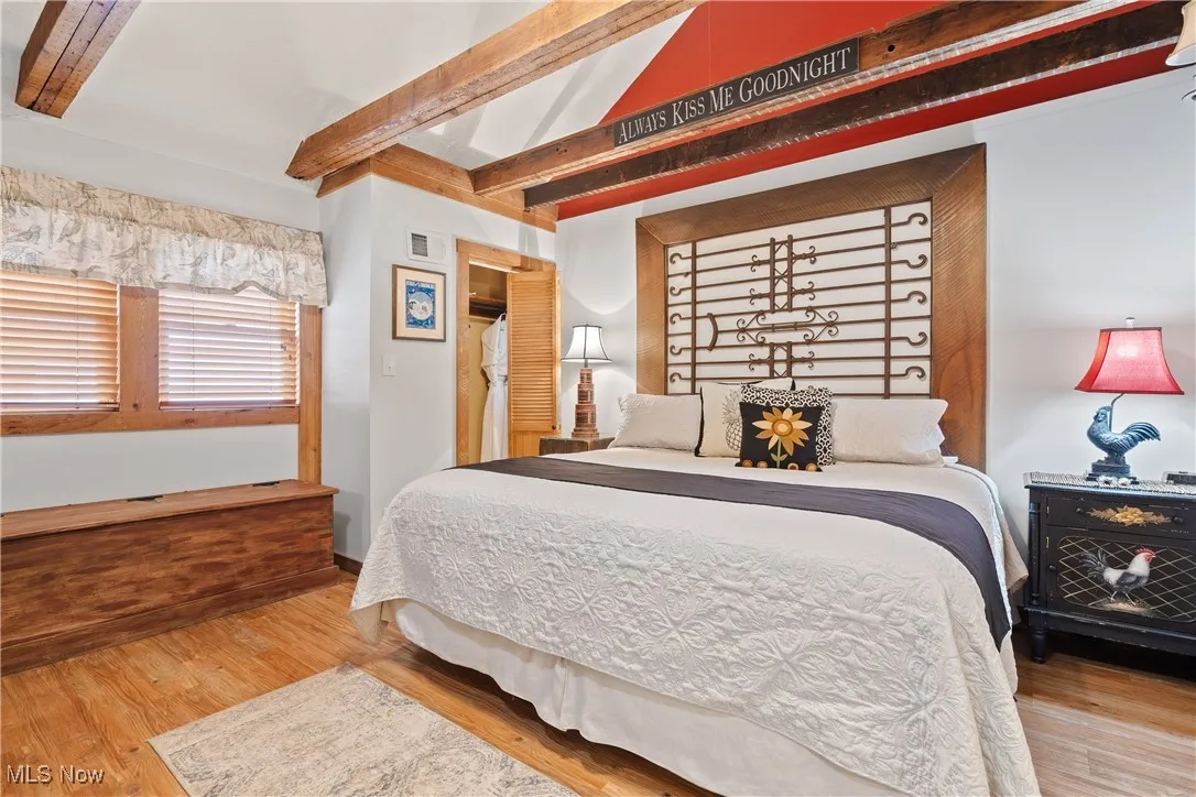 Rear unit Bedroom with vaulted beam ceiling and built-in window seat with storage
