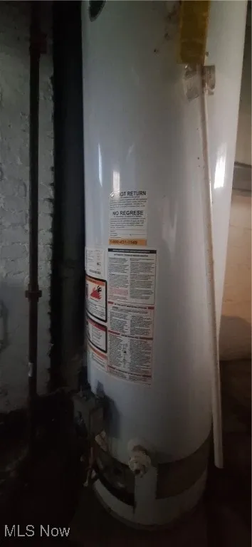 Utility room featuring water heater