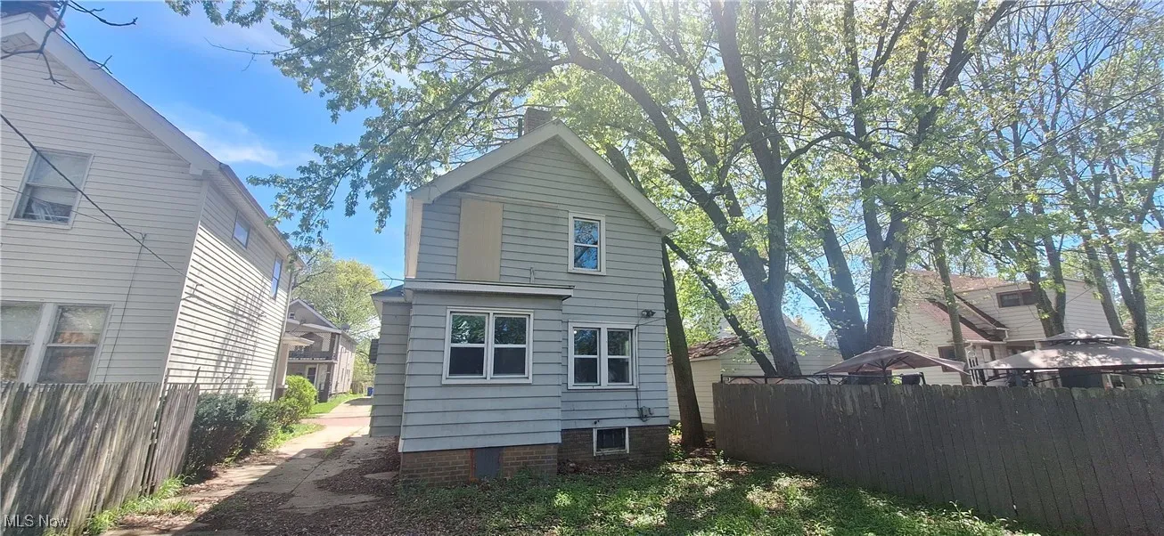 Rear view of house featuring fence