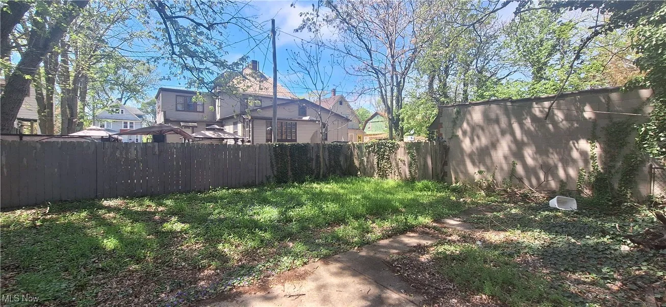 View of yard featuring fence