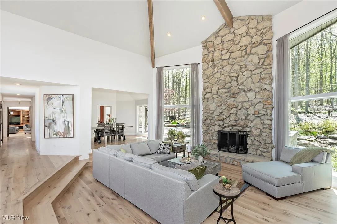 Great Room features a floor-to-ceiling stone Fireplace, flanked by oversized twin picture windows.