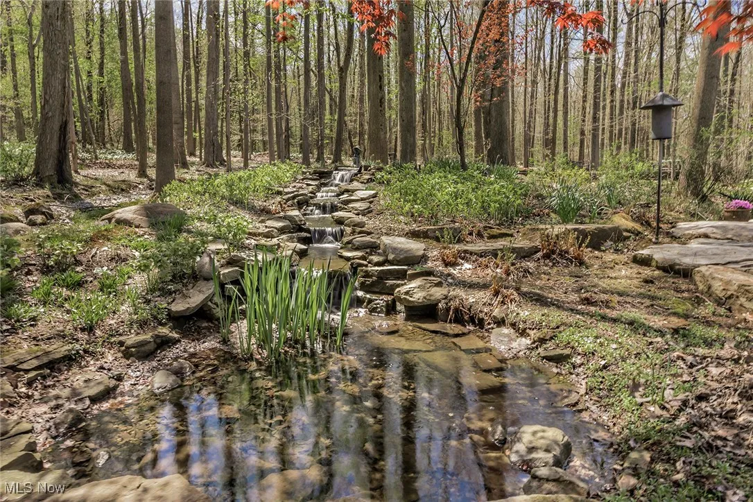 Sweet pond is fed by a small creek. Look closely and you will see the waterfall !  To the right is a bocce court.