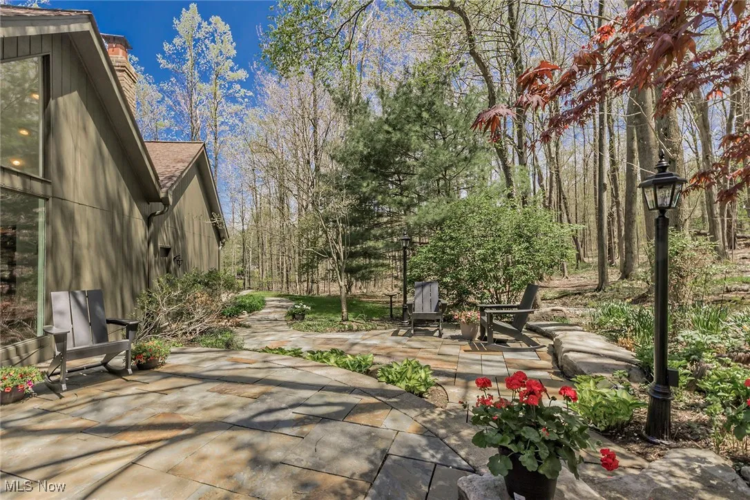 View of patio, showing the back of the house and some of the landscaping.