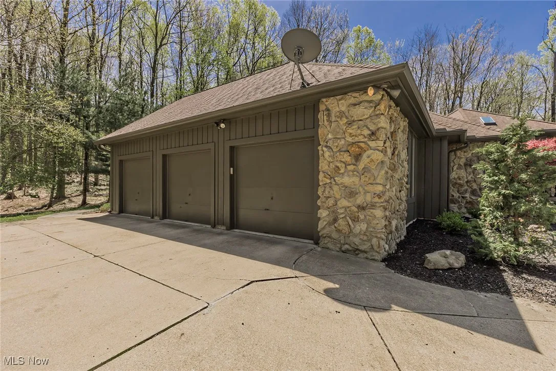 3 car side-load garage has naturestone floor.