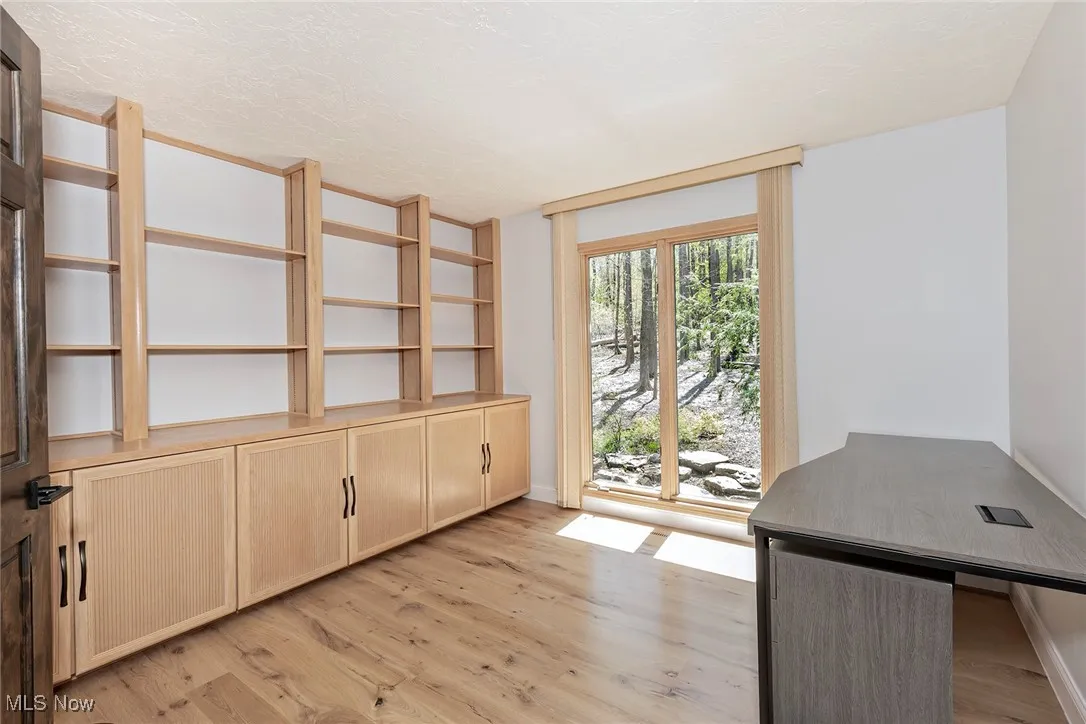 Second floor Office is outfitted with full wall of built-in bookshelves and cabinetry. This flexible space could also become an ideal craft or sewing room, child's game room or homework space. Or your hideaway spot to write the Great American Novel.