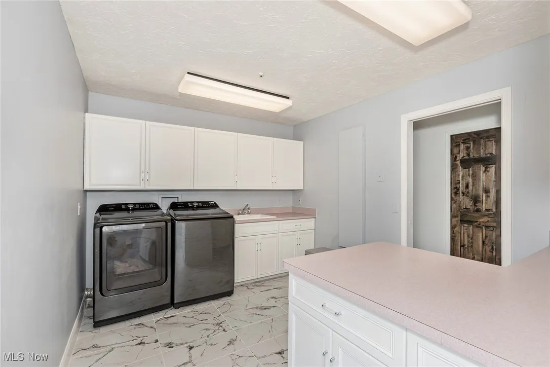 Laundry Room on the main floor is well-lit, organized with plenty of cabinet storage, and counter work space. There is a utility sink and also a closet in the right hand corner. Washer and Dryer are included.