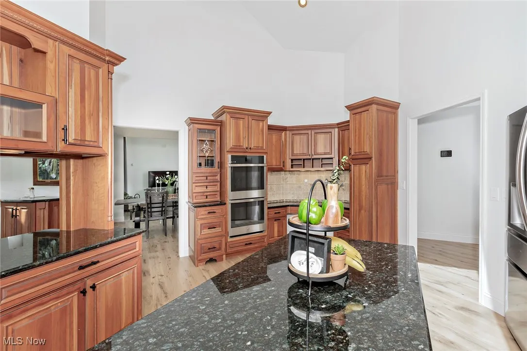 Kitchen with granite tops & island.  Skylight. There is a Pantry in the hall to the right.