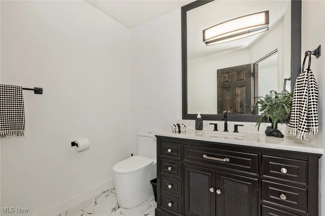 Fully renovated half-bath on the main floor is a beautiful powder room for guests.