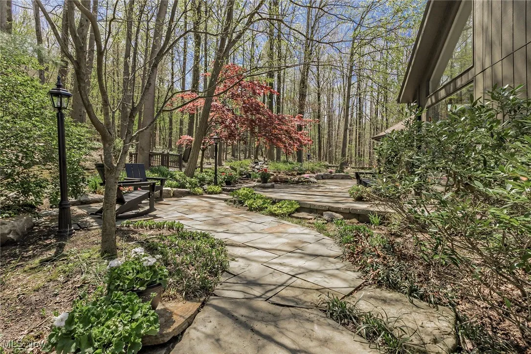 Stone walkways and patios meander around the back of the property.
