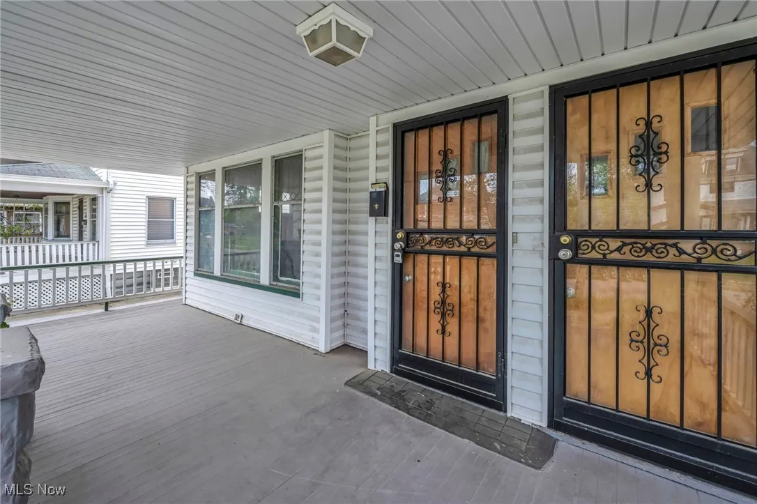 Doorway to property with covered porch