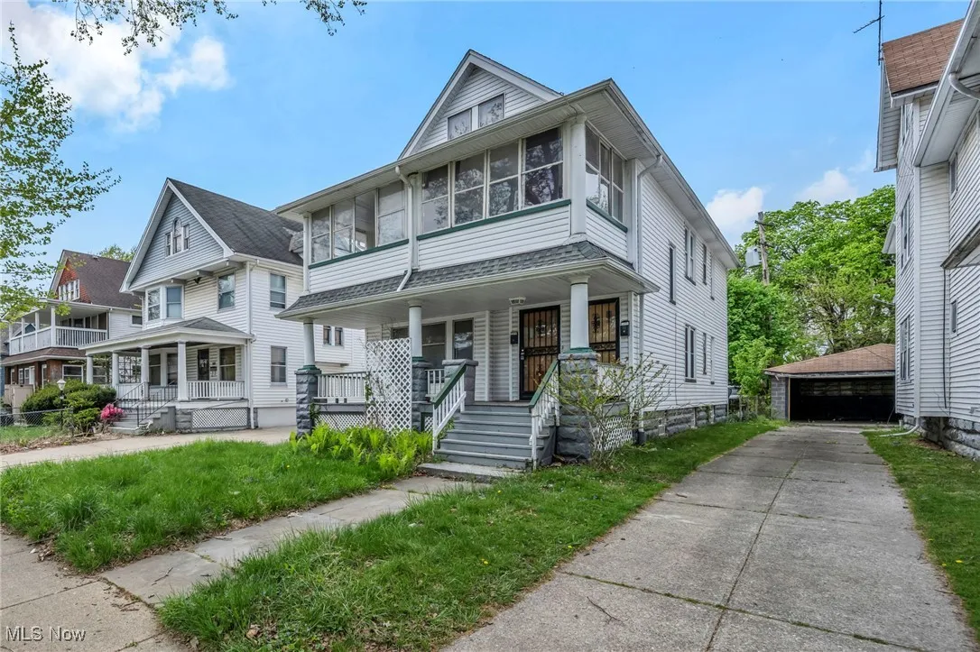 American foursquare style home with covered porch and an outdoor​​‌​​​​‌​​‌‌​‌‌​​​‌‌​‌​‌​‌​​​‌​​ structure