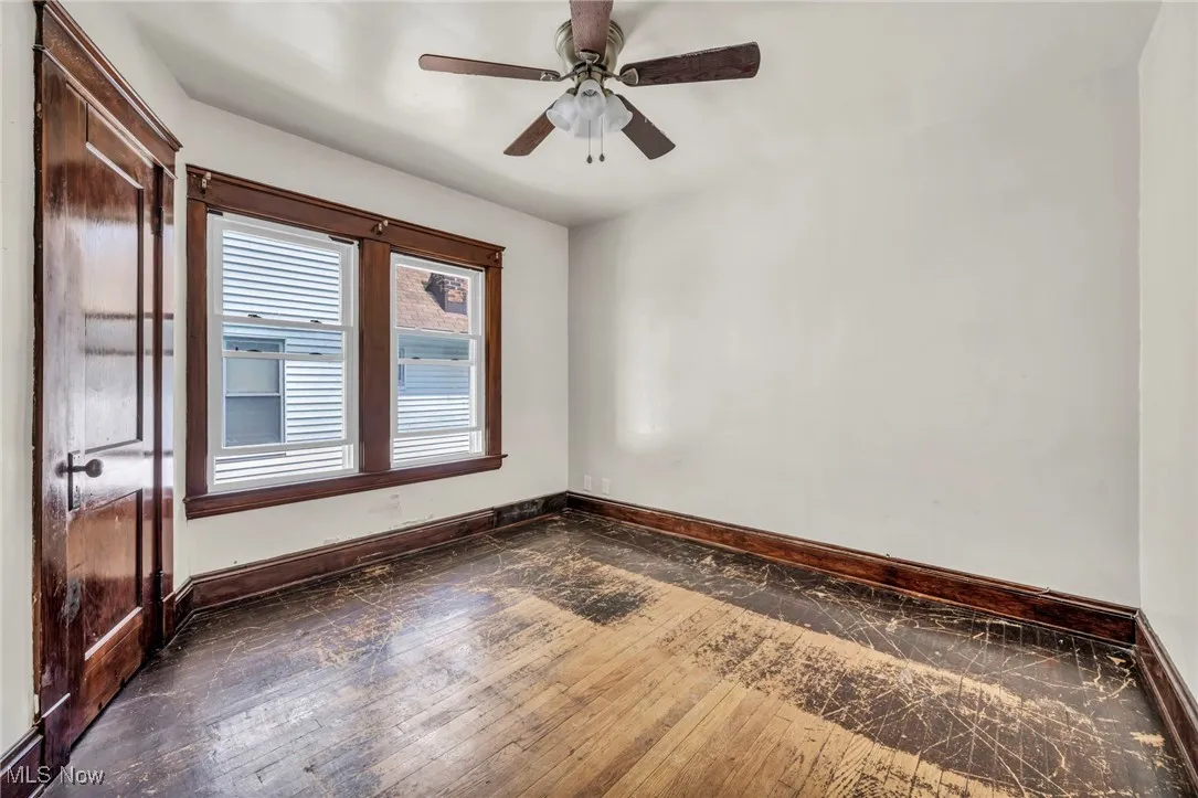 Empty room with a ceiling fan and baseboards
