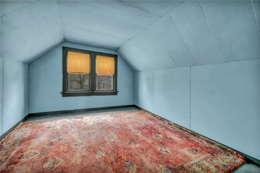 Additional living space featuring vaulted ceiling