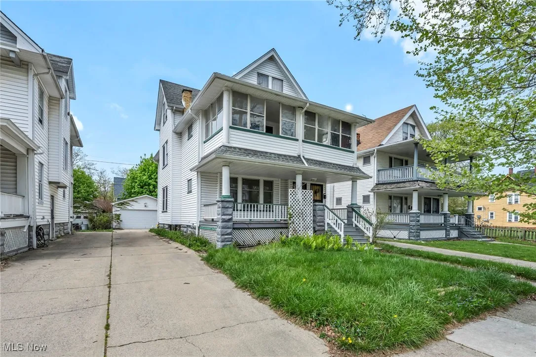Traditional style home with a porch and an outbuilding