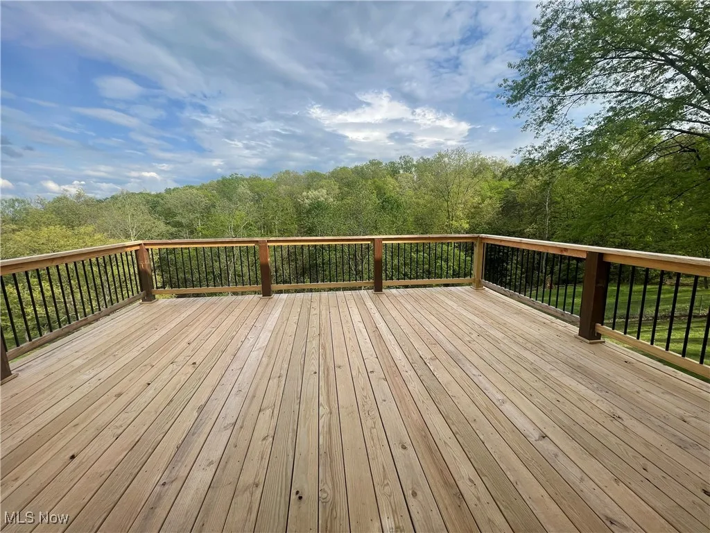 Wooden terrace featuring a forest view