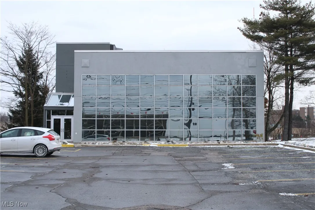 View of property with uncovered parking