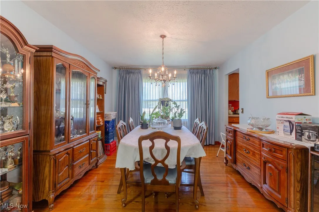 Dining space with an inviting chandelier and light wood finished floors