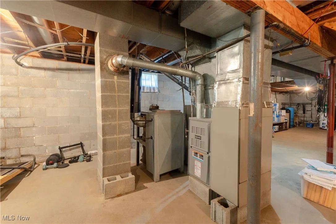 Unfinished below grade area featuring heating unit
