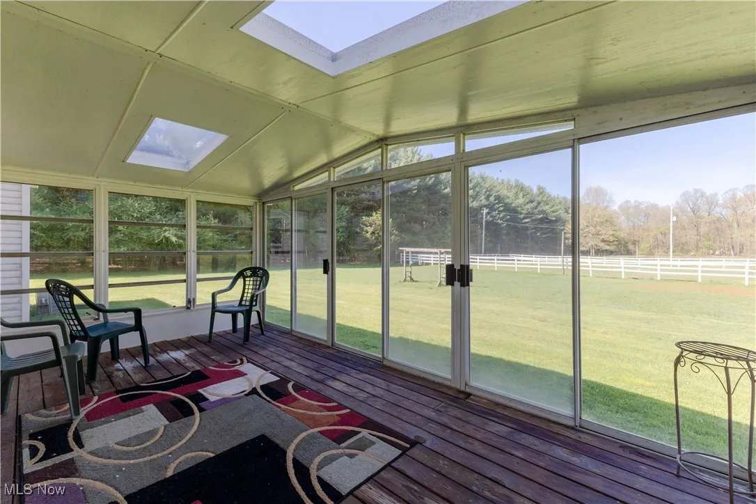 Sunroom / solarium featuring a skylight and plenty of natural light