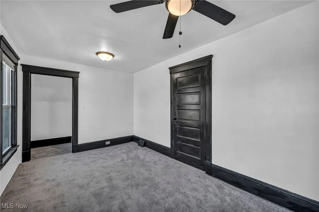 Unfurnished room featuring baseboards and carpet flooring