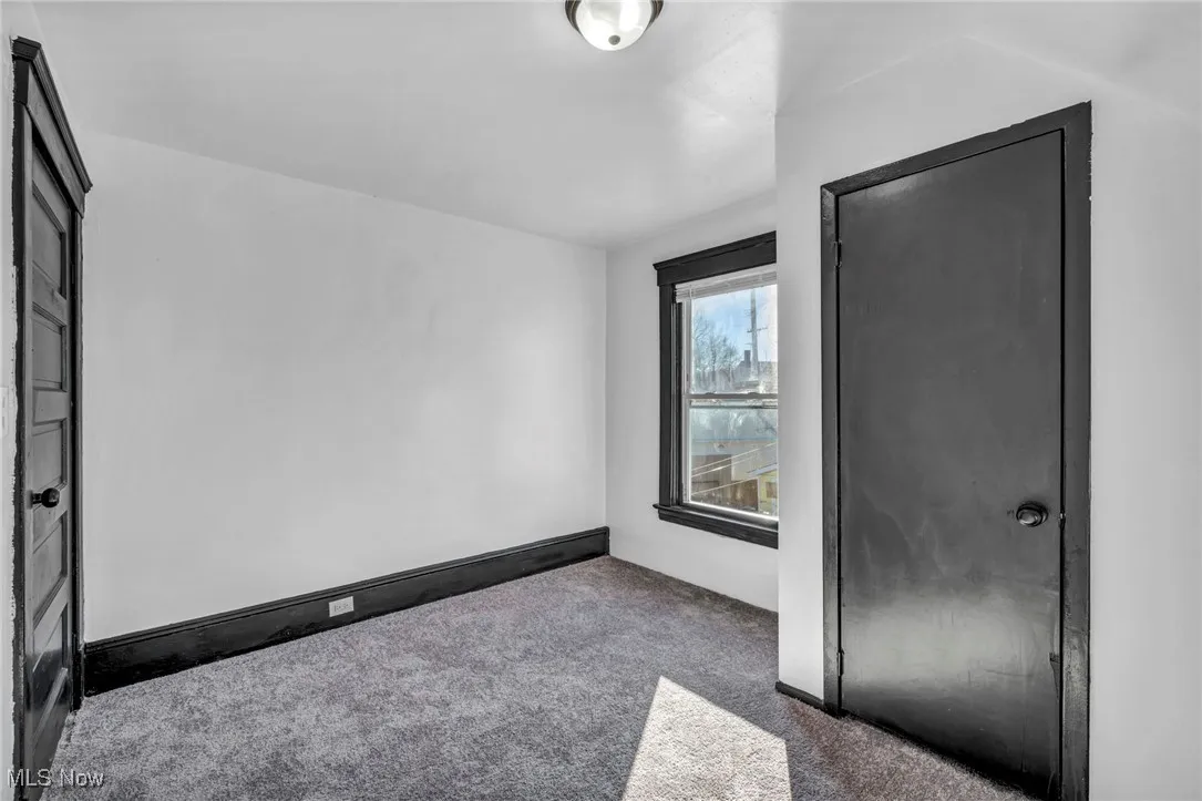 Carpeted spare room with baseboards
