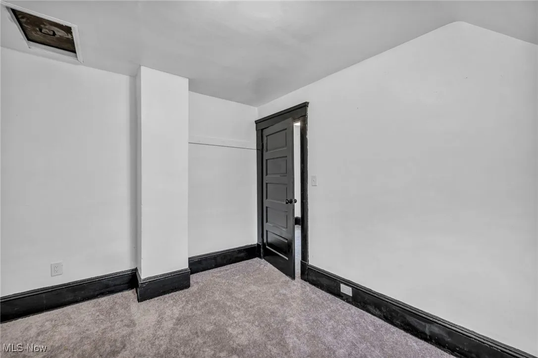 Unfurnished room with carpet flooring and baseboards