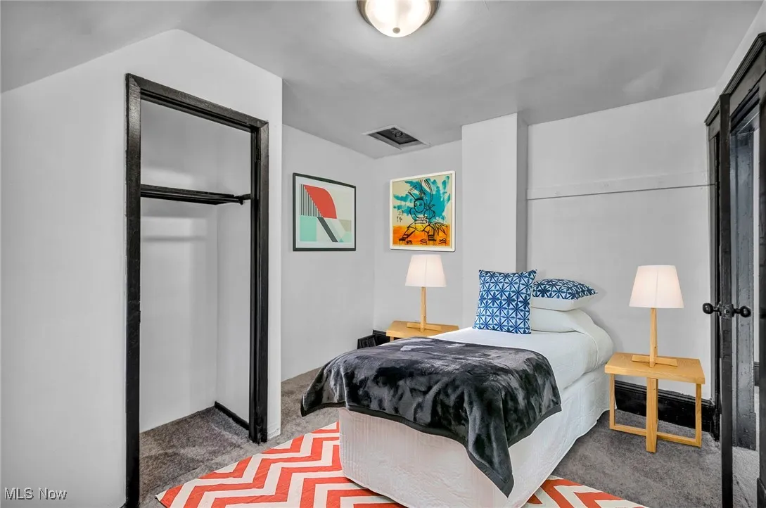 Bedroom featuring carpet and visible vents
