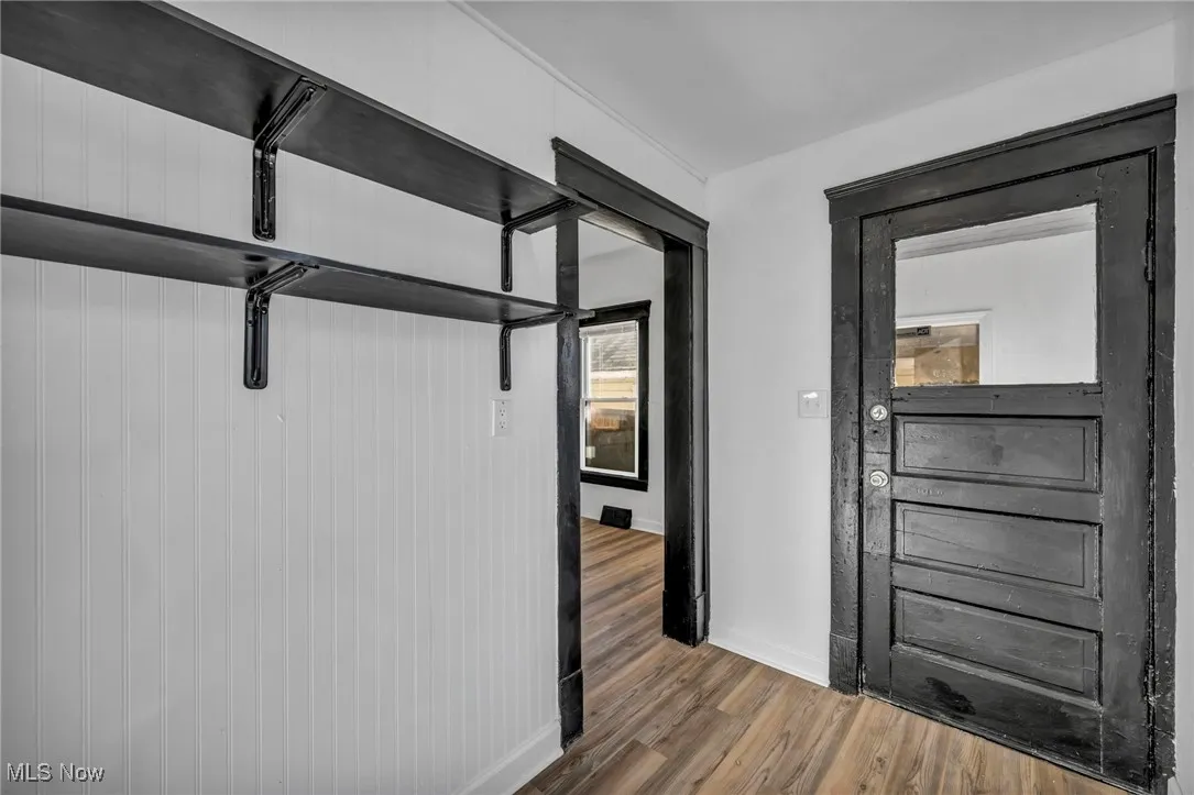Hall with baseboards and wood finished floors