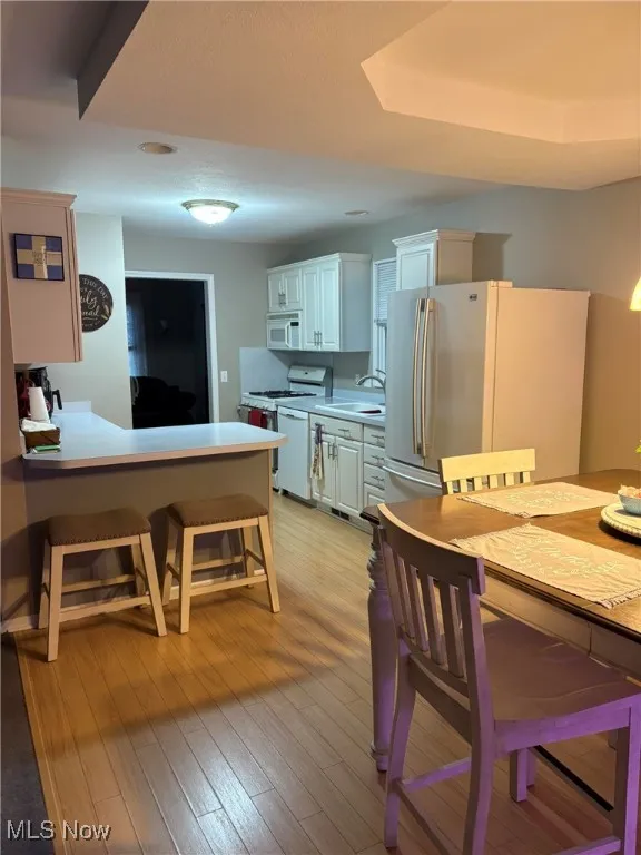 Dining area with light wood-style flooring